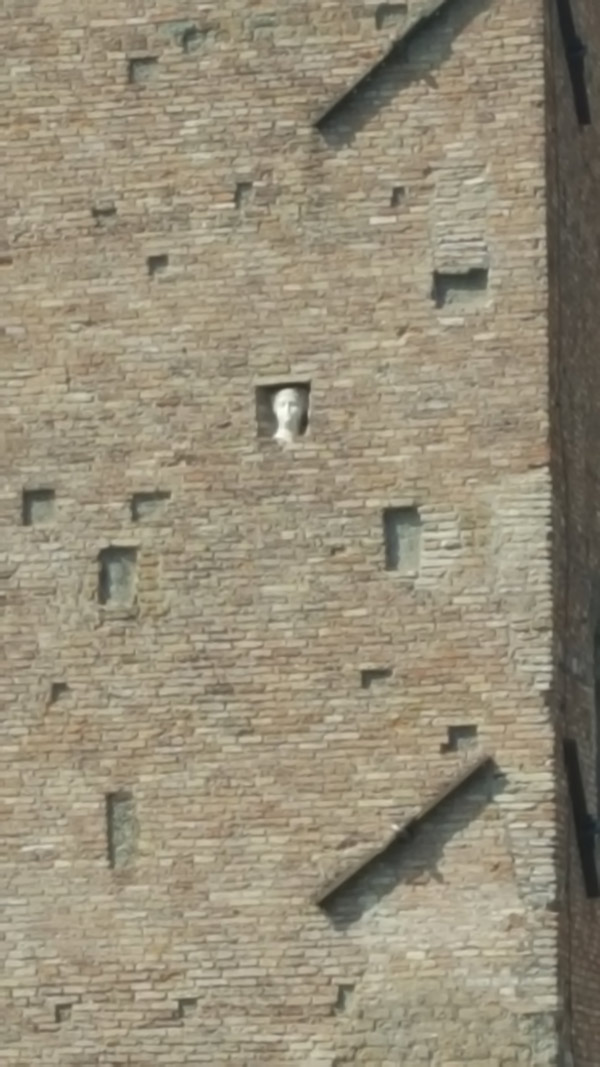 Carved face of a woman as you cross the Ponte Fabricio