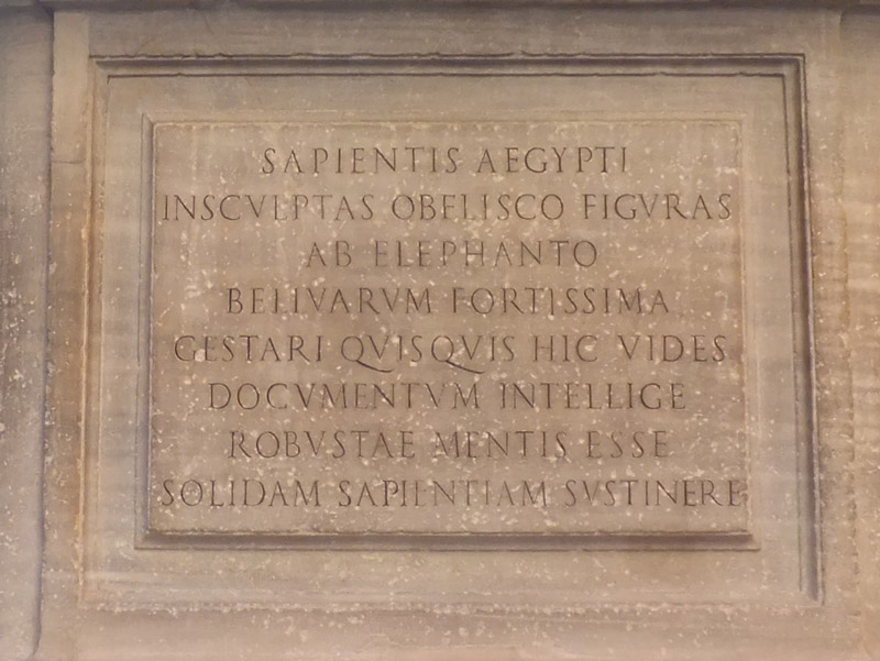 Latin text engraved on plinth on the Elephant and Obelisk statue